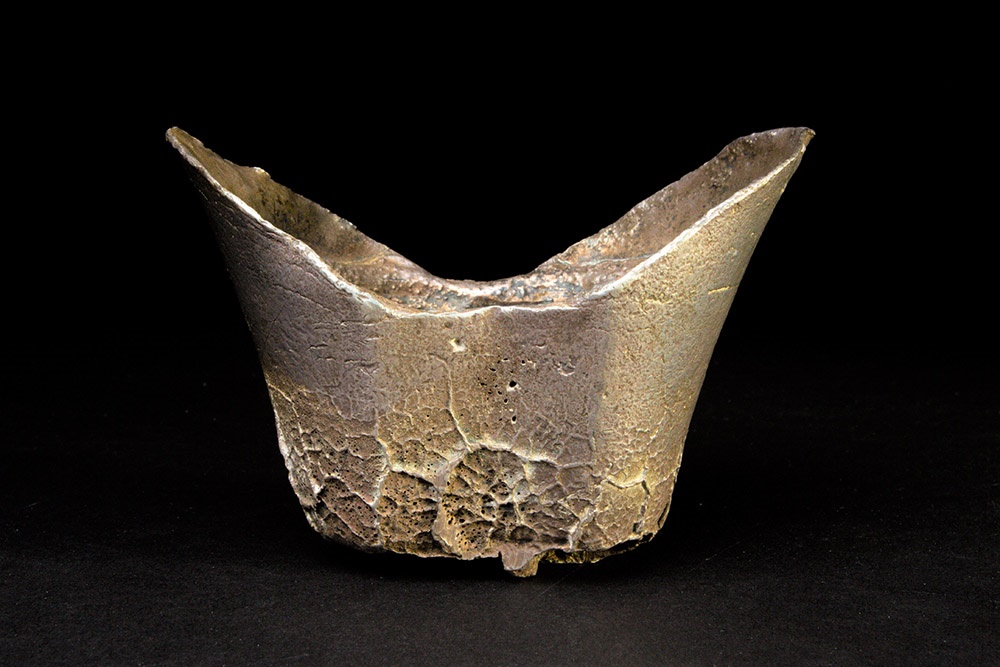 A Chinese sycee silver ingot of abstract boat form